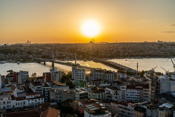 Istanbul at sunset view. Aerial wide angle view of the Golden Horn Metro Bridge and Galata Bridge at sunset. Istanbul, Turkey