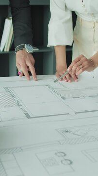 Businesspeople analyzing architectural drawings. 4k video