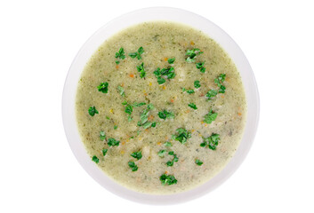 Homemade cream soup with chicken and herbs in a white plate on a white background.