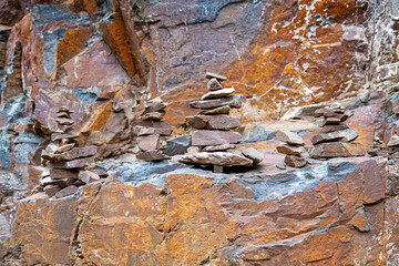 Stacked stones on a rocky cliff - Zen cairns in nature.