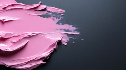 Pink creamy texture on a dark background, showing brush strokes and an abstract design.