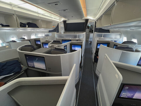 New Lufthansa Allegris long-haul Business Class cabin with fully enclosed suites with doors, staggered lie-flat seating layout onboard Airbus A350 taken after landing at Munich Airport on 9 July 2024