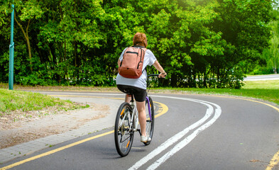 Fototapeta premium Cyclist ride on the bike path in the city Park 