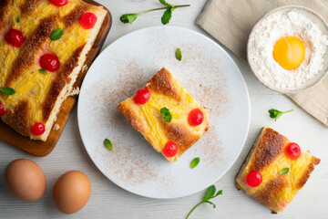 Coca San Juan, a traditional Catalan dessert similar to brioche with pastry cream and candied fruit. Top view table.