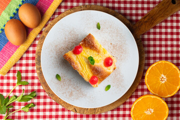 Coca San Juan, a traditional Catalan dessert similar to brioche with pastry cream and candied fruit. Top view table.