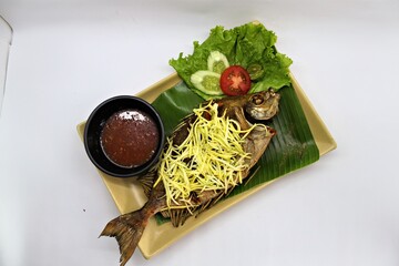Crispy fried rabbitfish (baronang) topped with spicy and tangy mango sauce. A flavorful Indonesian seafood dish served fresh and vibrant.