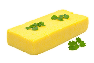 Yellow polenta block garnished with fresh cilantro leaves.