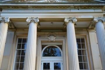 Obraz premium A close-up shot of a pedimented portico framing the main entrance of a stone building, A pedimented portico framing the main entrance
