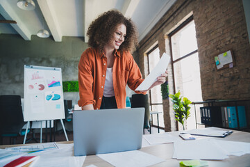 Professional Young Businesswoman Working Enthusiastically in a Modern Office Environment with...