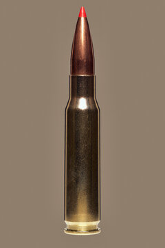 Close up studio shot .308 bullet cartridge on brown background
