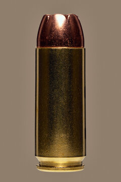 Close up studio shot .50 bullet cartridge on brown background
