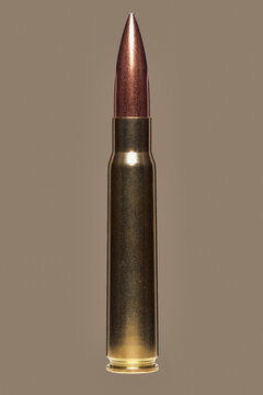 Close up studio shot 8 x 57 bullet cartridge on brown background
