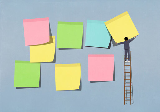 Businessman on ladder arranging multicolor adhesive notes on blue background
