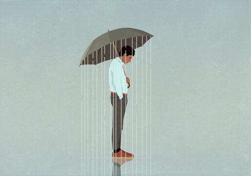 Rain falling from umbrella over depressed man
