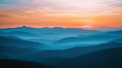 Obraz premium A misty sunset with layers of mountains fading into the distance.