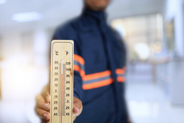 Technician use thermometers to measure temperatures inside offices or workplaces to optimize the environment for employees working inside the building