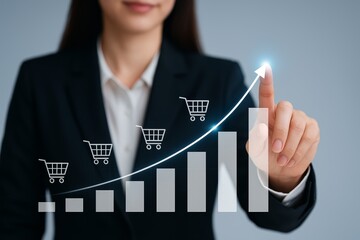Businesswoman touches rising shopping cart graph, symbolizing e-commerce growth and sales success.