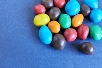 Colorful candies on blue background. Close up. Selective focus.