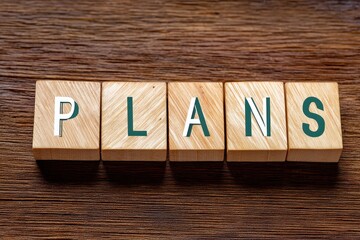 Wooden Blocks Spelling Plans Arrangement on Wooden Surface for Visual Concept of Planning Strategy and Organization