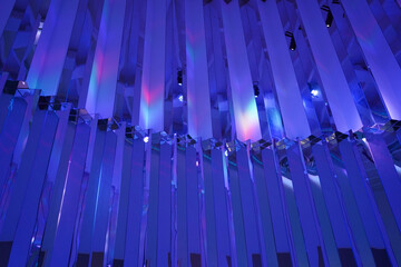 Abstract shimmery purple design pattern with rainbow reflections on the glitter wall