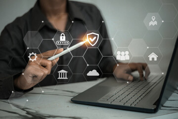A man pointing at a digital shield and lock icons representing cybersecurity and user access protection.