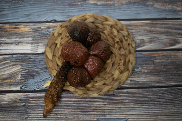 Kelubi fruit, placed on a natural woven coaster.