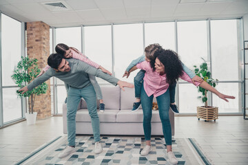 Happy young family playing together indoors, spending quality time bonding with children in a...