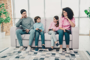 Young family enjoying quality time at home with video games in a bright modern living room