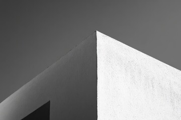 Geometric architectural detail of a light-toned building's corner.