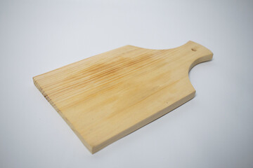 Natural wood chopping board with a handle, ideal for slicing vegetables or serving cheese.
