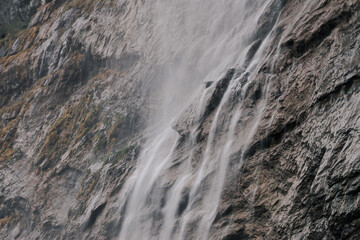 Crystal-clear waterfall flowing over rocks – scenic nature landscape