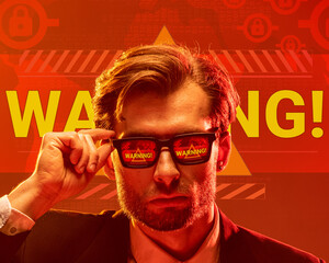 Conceptual design. Man in sunglasses reflecting word warning with glowing background, expressing...