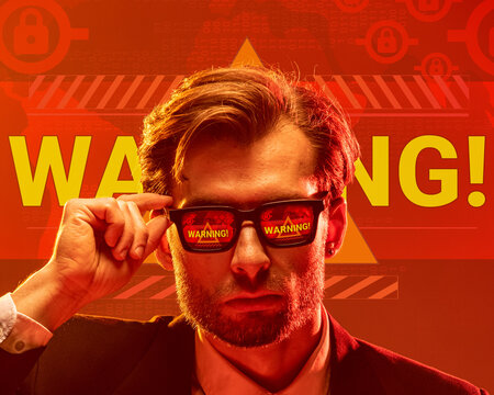 Conceptual design. Man in sunglasses reflecting word warning with glowing background, expressing urgency, collapse fear. Visual overlay. Concept of economic crisis and depression, hardship, tariffs.