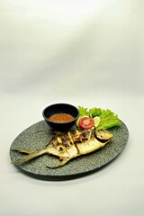 Grilled spadefish (bawal bintang) served with spicy seafood sambal. A savory Indonesian dish rich in flavor, perfect for traditional seafood lovers.