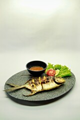 Grilled spadefish (bawal bintang) served with spicy seafood sambal. A savory Indonesian dish rich in flavor, perfect for traditional seafood lovers.