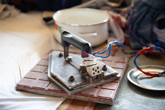Traditional indian electrical iron, Dhobi Ghat, open air laundry in Kochi, India, old working tool for ironing clothes