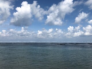 Serene Coastal Seascape: Cumulus Clouds and Calm Waters