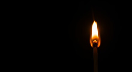 Matchstick flame isolated on dark background