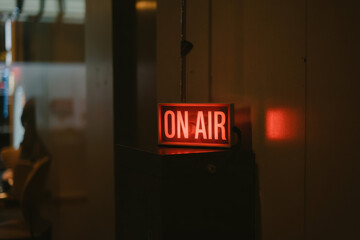 Retro 'On Air' Sign Illuminating Studio in Warm Glow for Live Broadcast