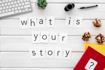 Office desk table with laptop keyboard and lumps paper drafts. Writer or blogger working space