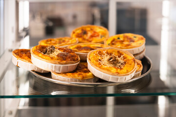 Appetizing mini quiches in the window of a coffee shop or cafe.