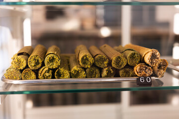 Wafer rolls with condensed milk, decorated with pistachio in a coffee shop.