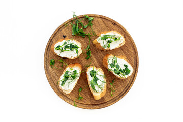 Toasts with with cream cheese and micro greens peas, healthy snack. Top view