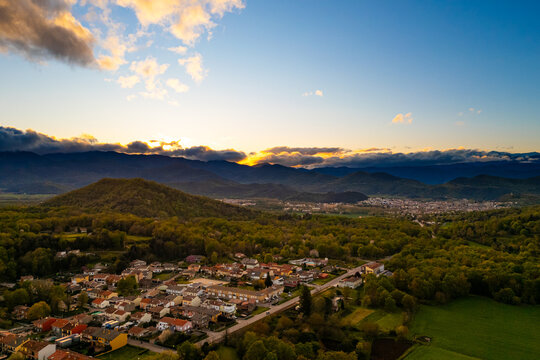 spectacular aerial view of Garrotxa region in Catalonia, Spain, at sunset with cloudy sky. Scenic view of natural landscape nearby Olot