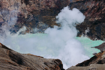 Mount Aso Nakadake volcano crater, Aso-San, caldera, Aso-Kuju National Park hiking, Kyushu island region, Kumamoto prefecture, Japan, eruption with steam and smoke, volcanic desert landscape view