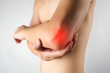Man has pain in his elbow and tendon muscles and he relieves the pain with a massage. Health and healing concept
