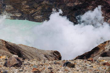 Mount Aso Nakadake volcano crater, Aso-San, caldera, Aso-Kuju National Park hiking, Kyushu island region, Kumamoto prefecture, Japan, eruption with steam and smoke, volcanic desert landscape view