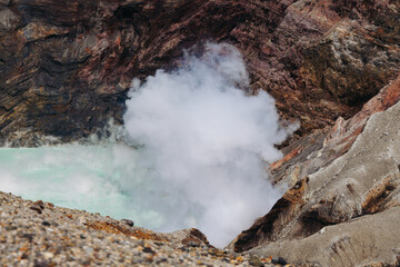 Mount Aso Nakadake volcano crater, Aso-San, caldera, Aso-Kuju National Park hiking, Kyushu island region, Kumamoto prefecture, Japan, eruption with steam and smoke, volcanic desert landscape view