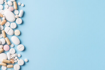 Diverse collection of medications for various health conditions on a blue surface