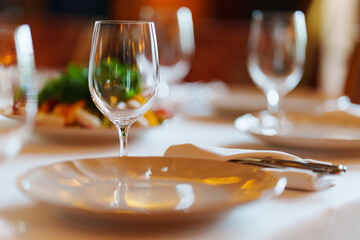 An empty wine glass on a table served for a banquet. 